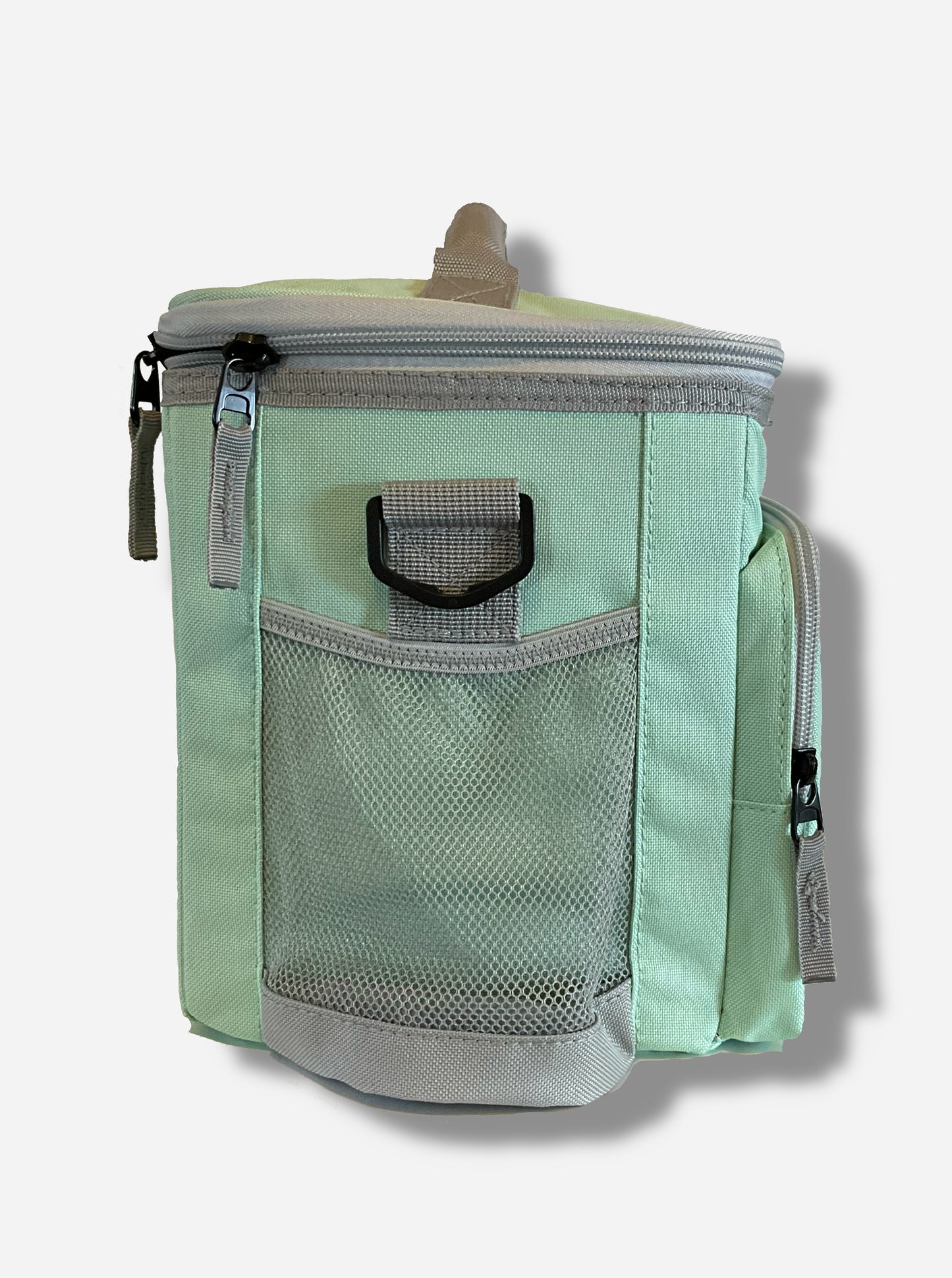 A picture of a the side of a lunch box cooler.  The outer surface is made of mint colored polyester.  A mesh pouch made of grey fabric can be seen on the side.  Several zippers with small fabric pull handles threaded through them can be seen.