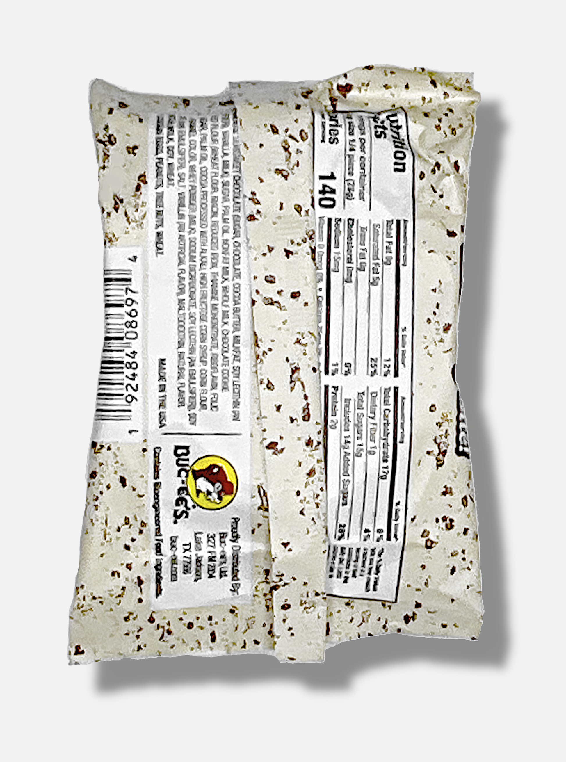 A picture of the back of a package of a dark chocolate cookies and cream Buc-ee's OverBite.  The package is metallic and white, with brown flecks, and has a small picture of the Buc-ee's logo on the back.  A picture of a package of a dark chocolate cookies & cream Buc-ee's OverBite.  