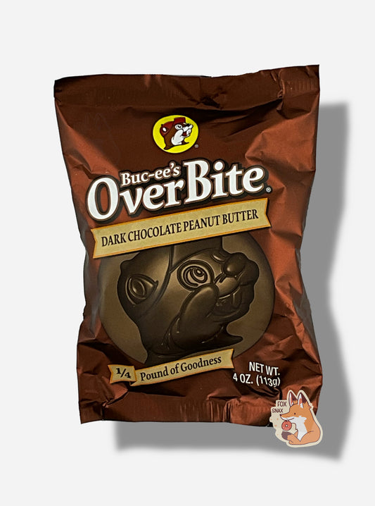 A picture of a package of a dark chocolate peanut butter Buc-ee's OverBite.  The package is metallic and dark brown, and features a large picture of the candy, which is shaped like the Buc-ee's beaver mascot logo.  The package reads BUC-EE's OVERBITE, then DARK CHOCOLATE PEANUT BUTTER, then 1/4 POUND OF GOODNESS.