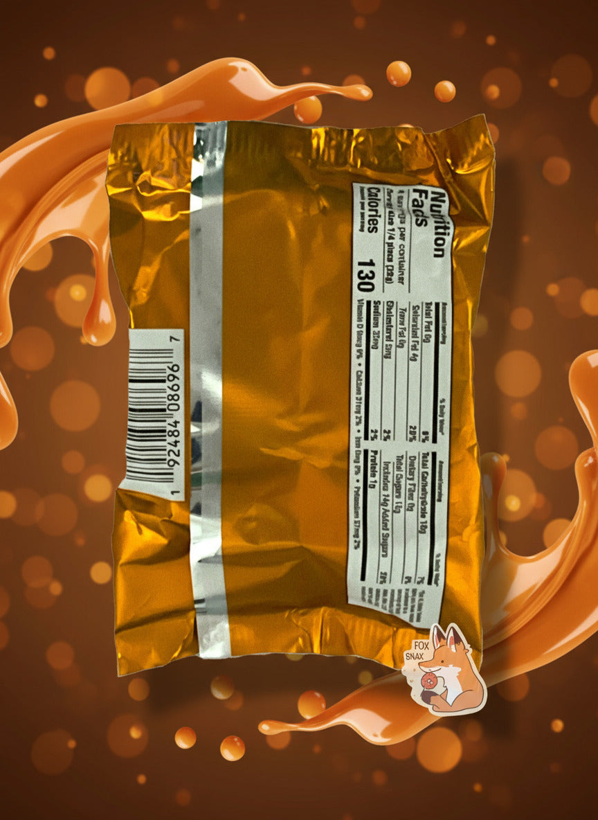 A picture of the back of a package of a dark chocolate peanut butter Buc-ee's OverBite.  The package is metallic and tan/light orange. The background shows a swirl of caramel surrounding the bag.