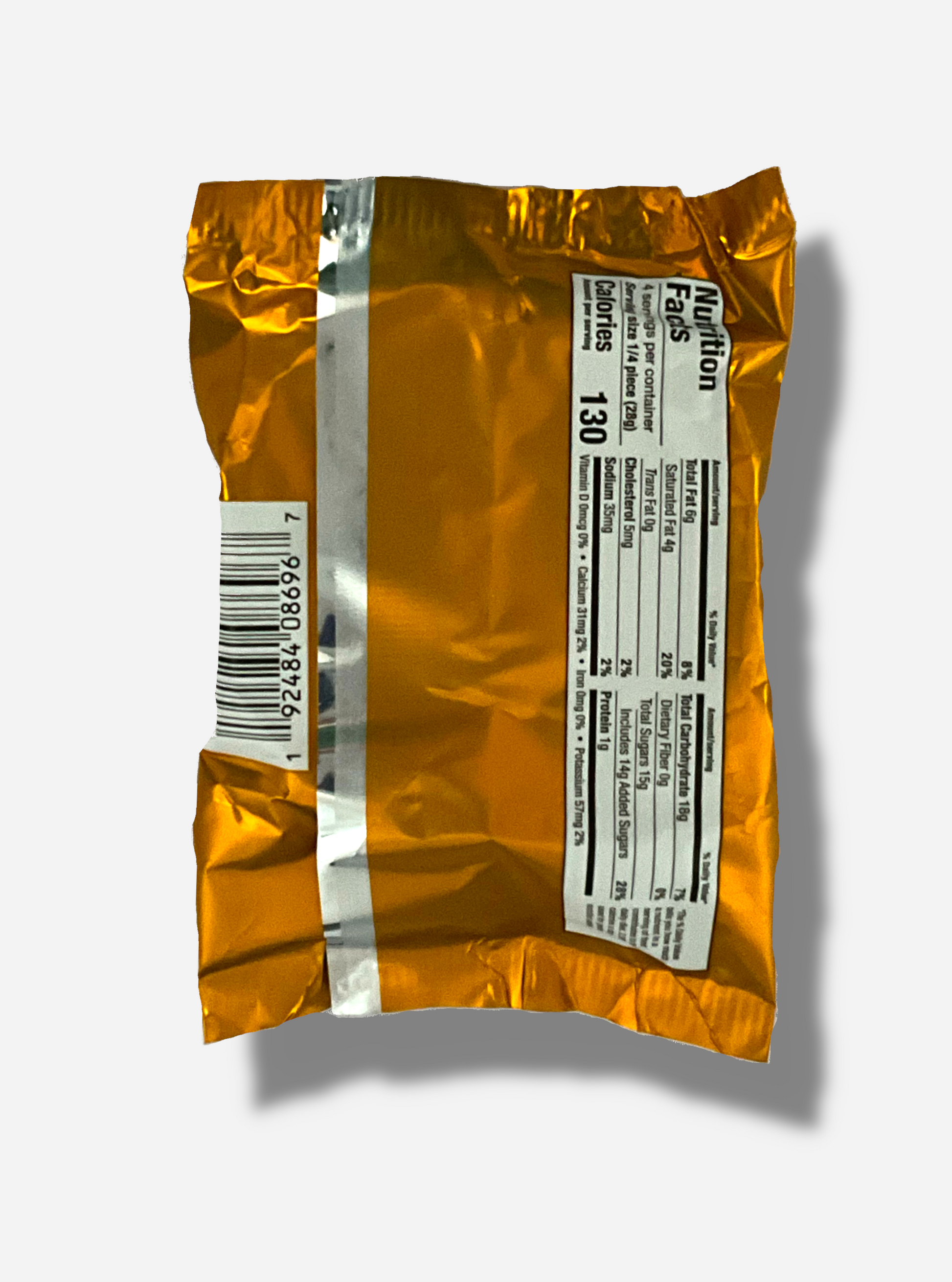 A picture of the back of a package of a dark chocolate peanut butter Buc-ee's OverBite.  The package is metallic and tan/light orange.