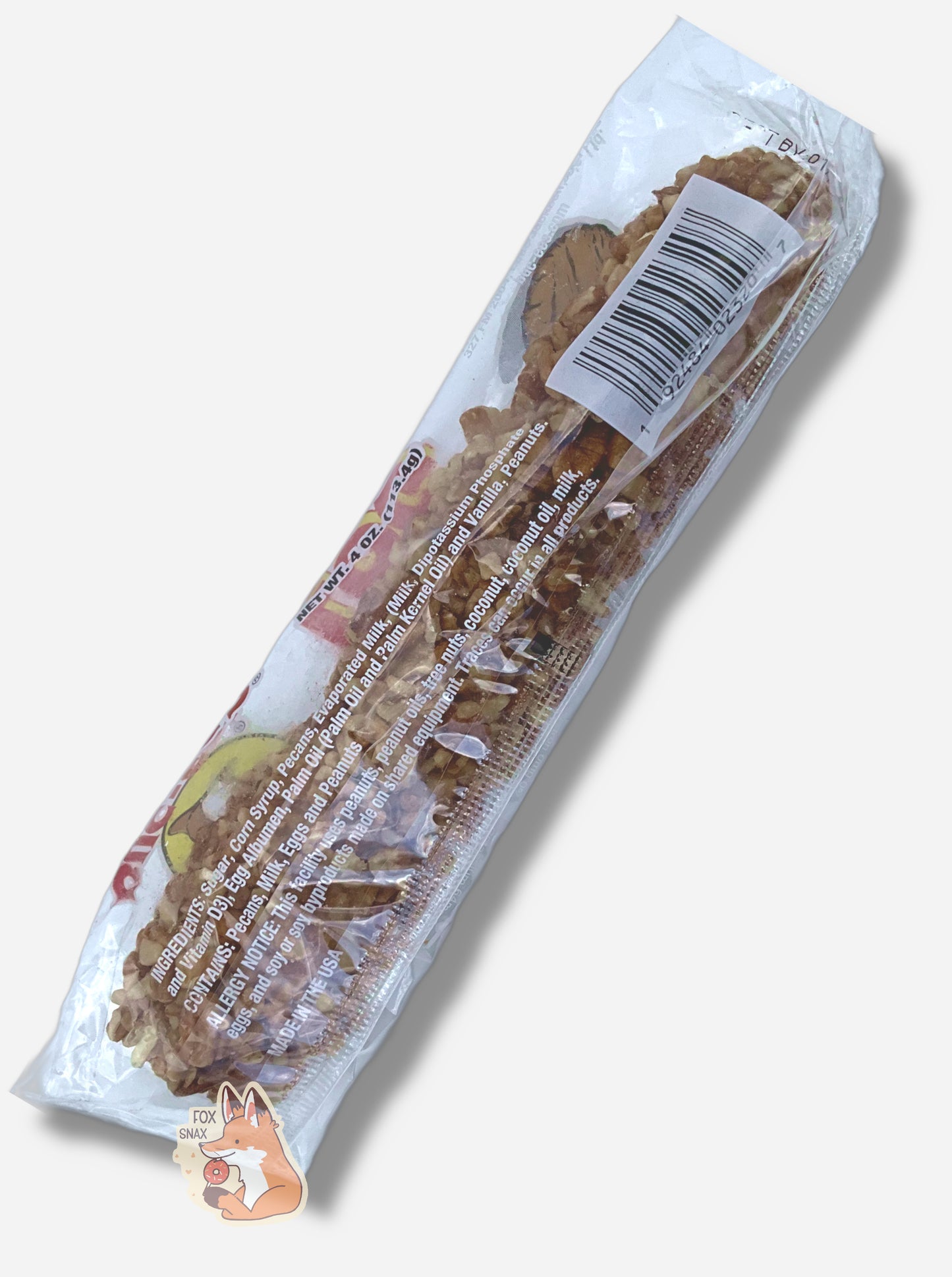 A picture of the back of a long, rectangular, clear plastic package of Buc-ee's Pecan Log.  Inside the package is a long thin cylinder; the surface of the cylinder is covered in small chopped bits of pecans.  The writing on the package show ingredients and nutrition facts.
