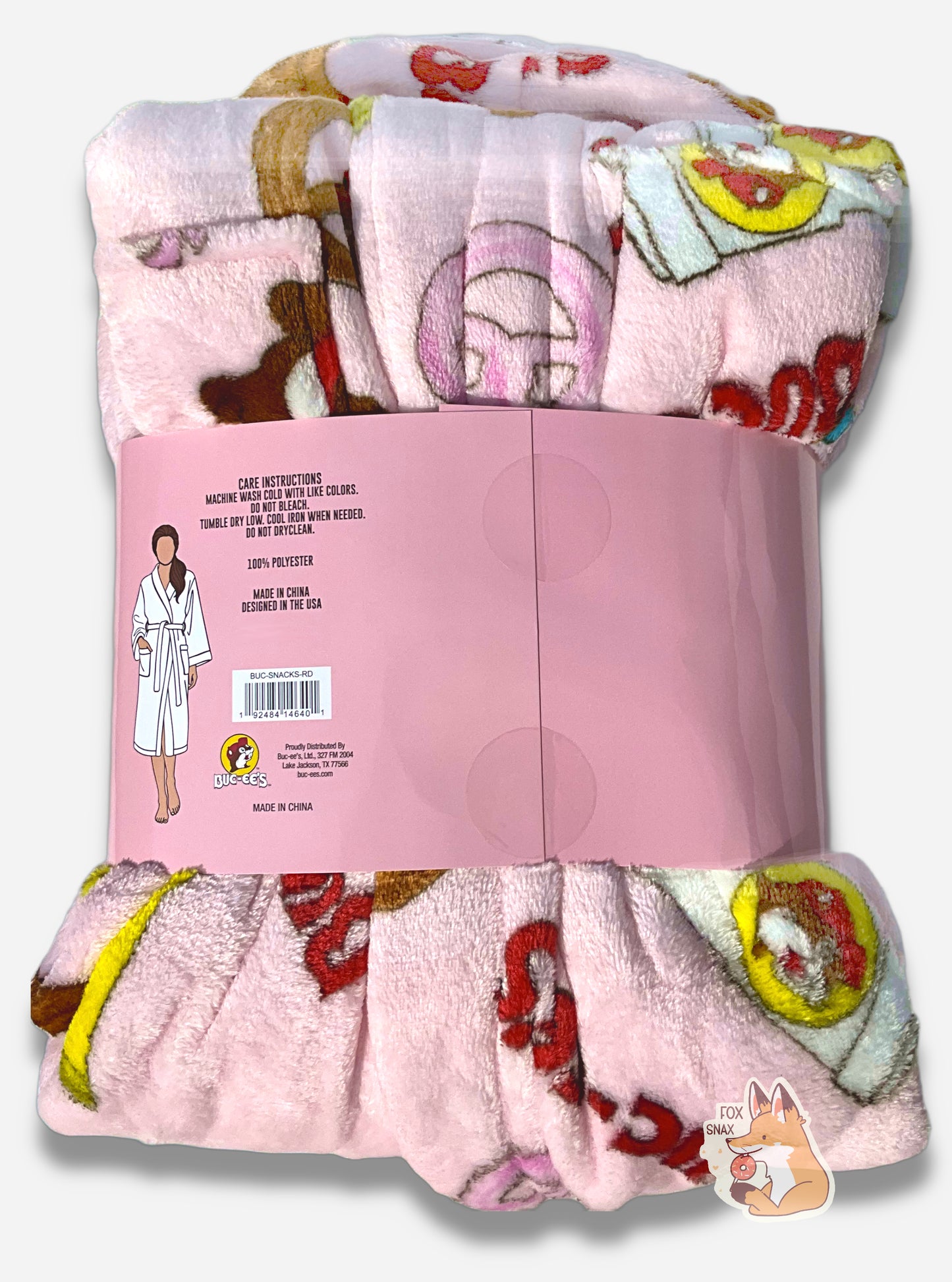An image the back of a plush, wrapped, pink robe.  The surface is pink and fluffy, and is studded with blue and pink gummi bear pictures, drink cup picture, pretzels, brisket sandwiches, and the text "BUC-EE'S" in red and blue.  A cardboard wrapper around the "waist" of the robe shows the a picture of a woman wearing a representation of the robe, and reads "CARE INSTRUCTIONS", then "MACHINE WASH COLD WITH LIKE COLORS. DO NOT BLEACH. TUMBLE DRY LOW. COOL IRON WHEN NEEDED. DO NOT DRYCLEAN. 100% POLYESTER"