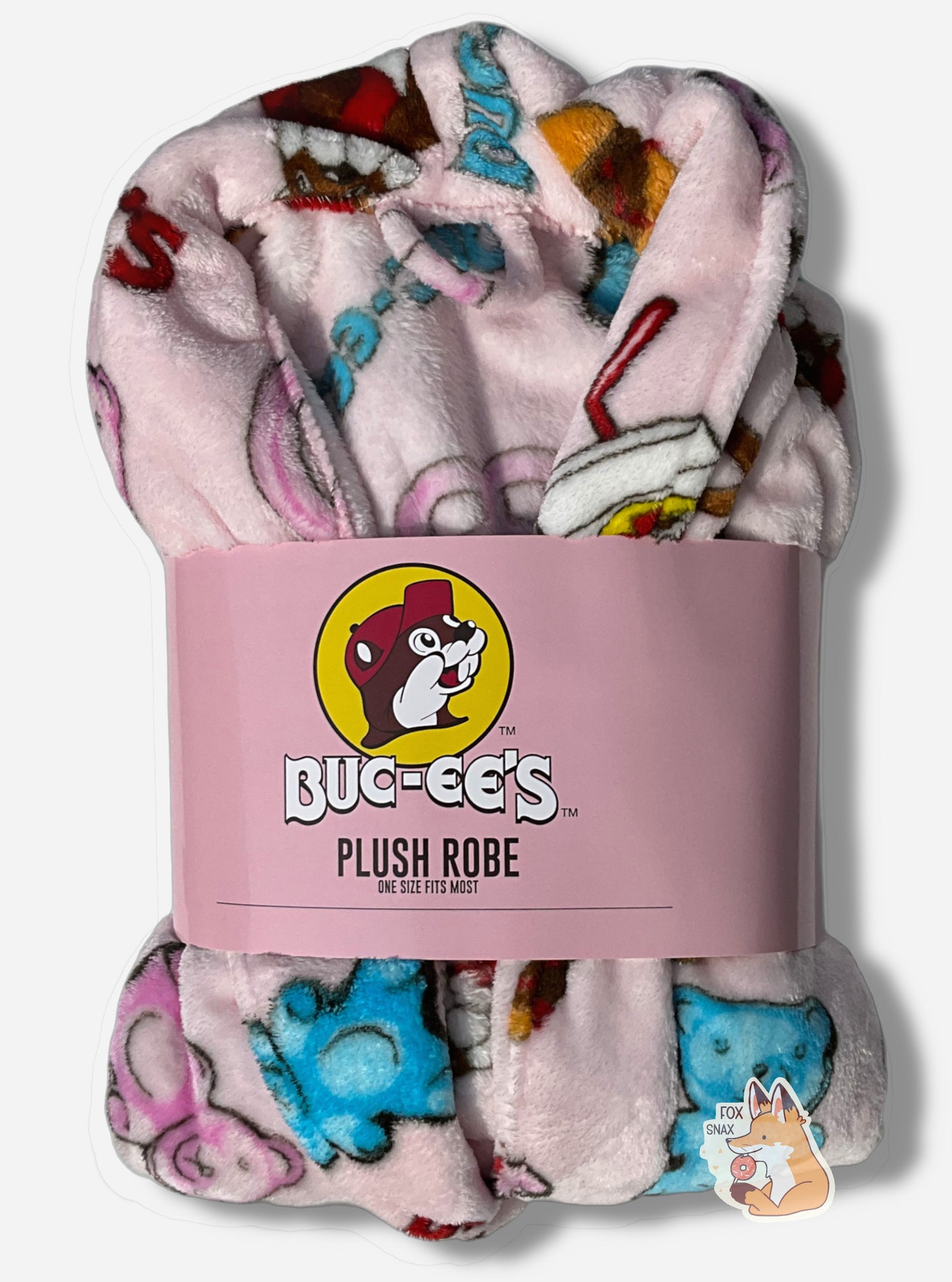 An image of a plush, wrapped, pink robe.  The surface is pink and fluffy, and is studded with blue and pink gummi bear pictures, drink cup picture, pretzels, brisket sandwiches, and the text "BUC-EE'S" in red and blue.  A cardboard wrapper around the "waist" of the robe shows the Buc-ee's logo and reads "PLUSH ROBE", then, underneath that "ONE SIZE FITS MOST"
