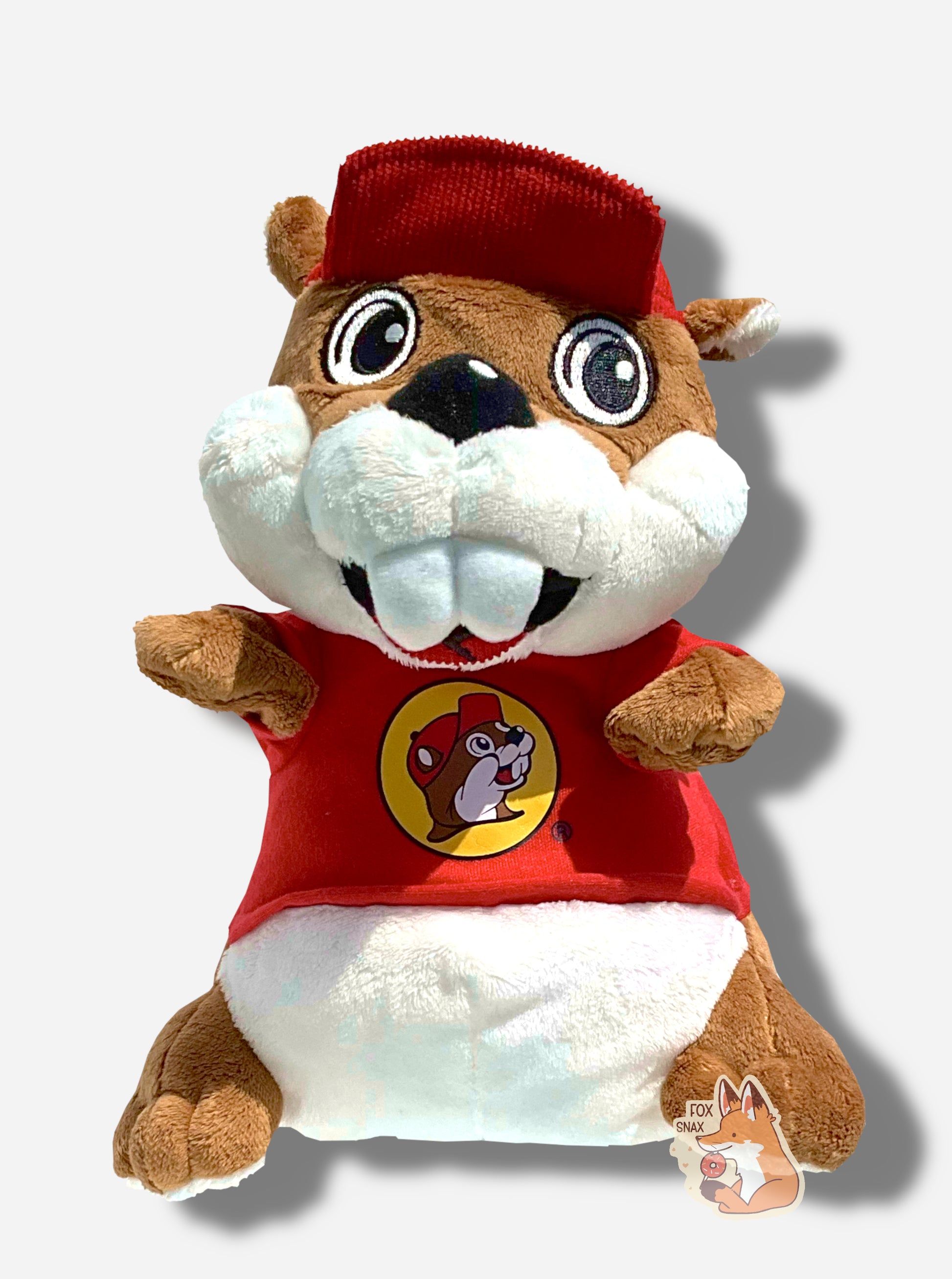 A Buc-ee the Beaver hand puppet.  Buc-ee is covered in brown and white fur, and has a big buck-tooth grin.  On his head is a red ball cap, and he's wearing a red t-shirt with the Buc-ee's logo.