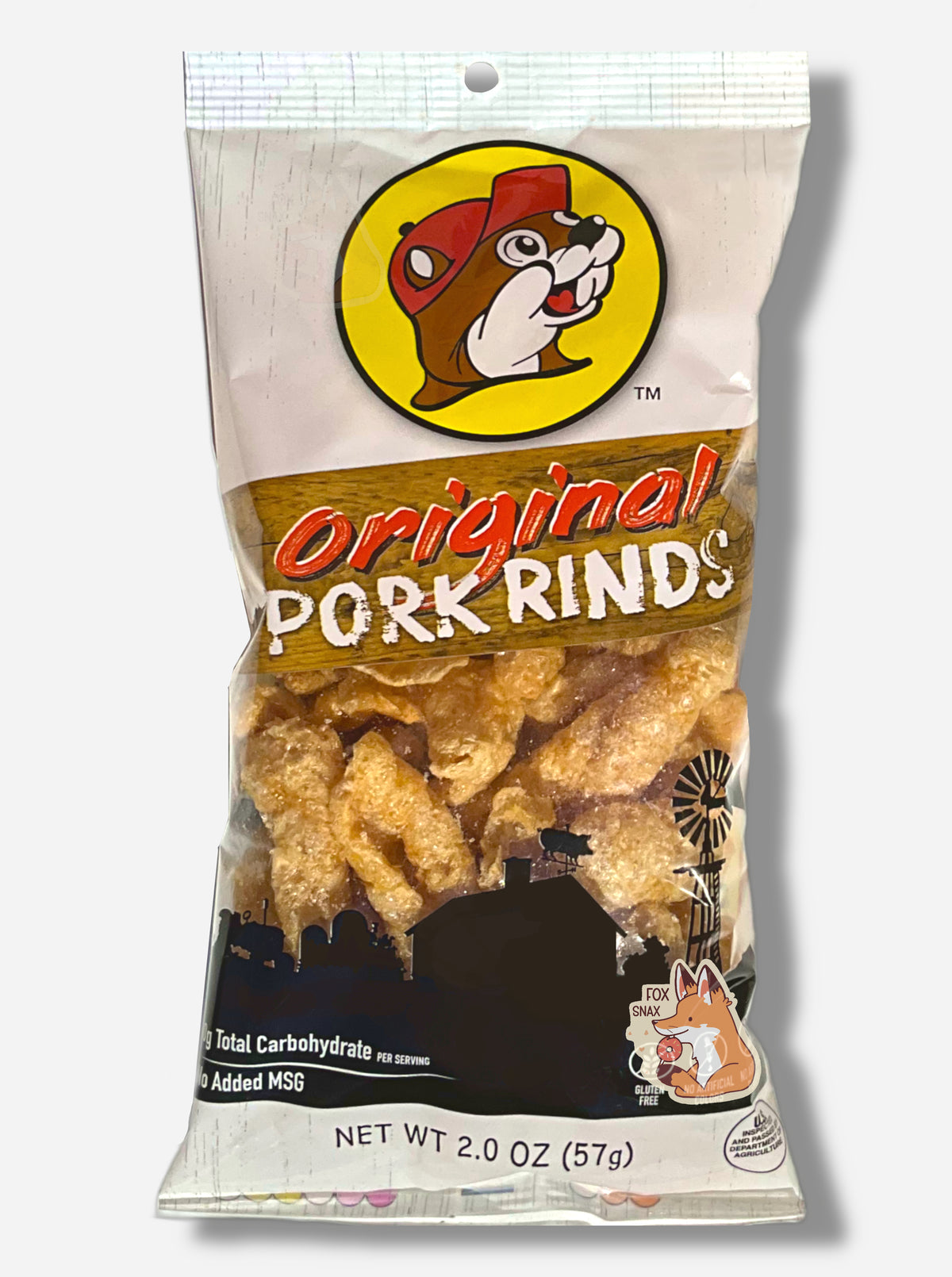 The front of a package of Buc-ee's Original Pork Rinds. The package is a clear and white plastic, roughly rectangular package, with red and white text that reads ORIGINAL PORK RINDS.  Inside the package are a series of oblog tan pork rinds.  The bottom of the package has a black outline of a farm, and reads 0g TOTAL CARBOHYDRATE PER SERVING, and NO ADDED MSG, then NET WT 2.0 OZ (57 g)