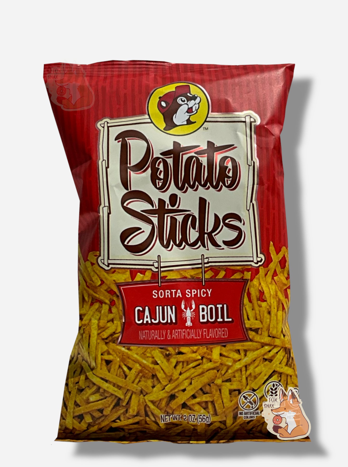 A bag of Buc-ee's Sorta Spicy Cajun Boil Flavored Potato Sticks.  The bag is in dark red and red, and has a white sign in the middle in black text that reads POTATO STICKS, then under that, SORTA SPICY CAJUN BOIL.  A large number of skinny (skinnier than french fries) potato sticks frame the bottom of the bag.