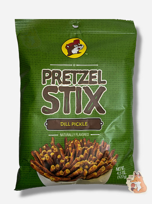 A picture of the front of a green bag of Buc-ee's Pretzel Stix, Dill Pickle flavor.  The bag reads NATURALLY FLAVORED.  At the top is the Buc-ee's logo - a cheerful beaver wearing a red ball cap.  The middle reads PRETZEL STIX in a brown font, then DILL PICKLE, then NATURALLY FLAVORED.  A large white bowl containg a plethora of coated pretzel sticks is on the bottom.