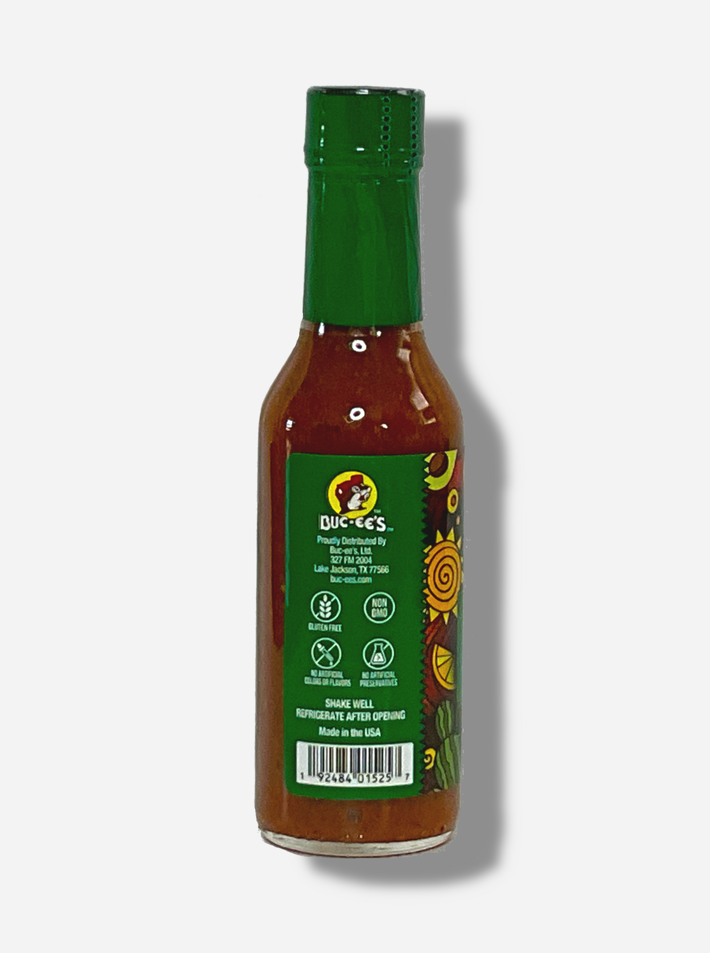 A picture of a small, tall bottle of hot sauce. The top of the bottle is sealed with a shiny green plastic top.  The back reads GLUTEN FREE, NON GMO, NO ARTIFICIAL COLORS OR FLAVORS, NO ARTIFICIAL PRESERVATIVES, then SHAKE WELL and REFRIGERATE AFTER OPENING.  Made in the USA.  The sauce inside is dark orange.