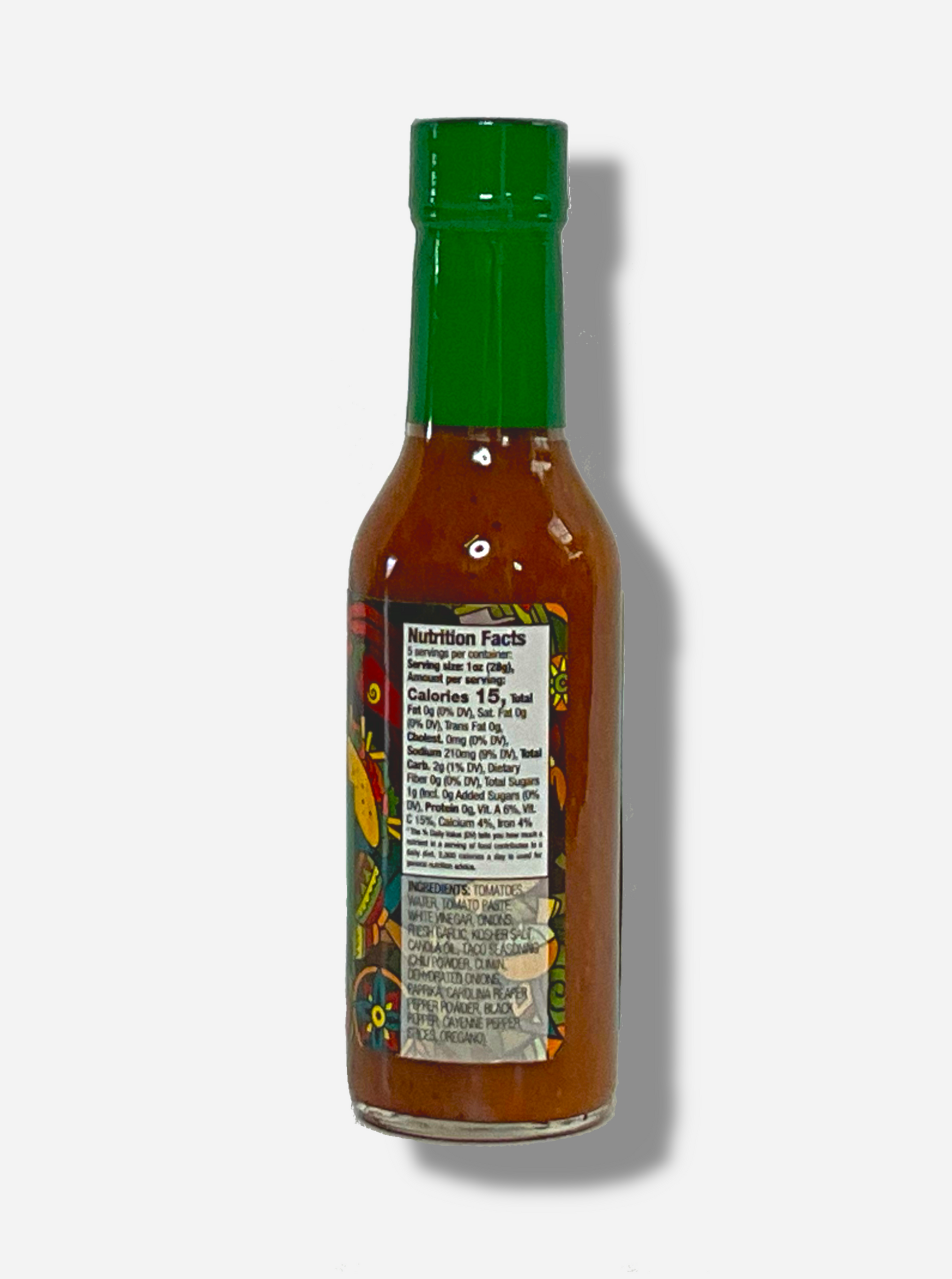 A picture of a small, tall glass bottle of hot sauce. The top of the bottle is sealed with a shiny green plastic top. The sauce inside is dark orange.