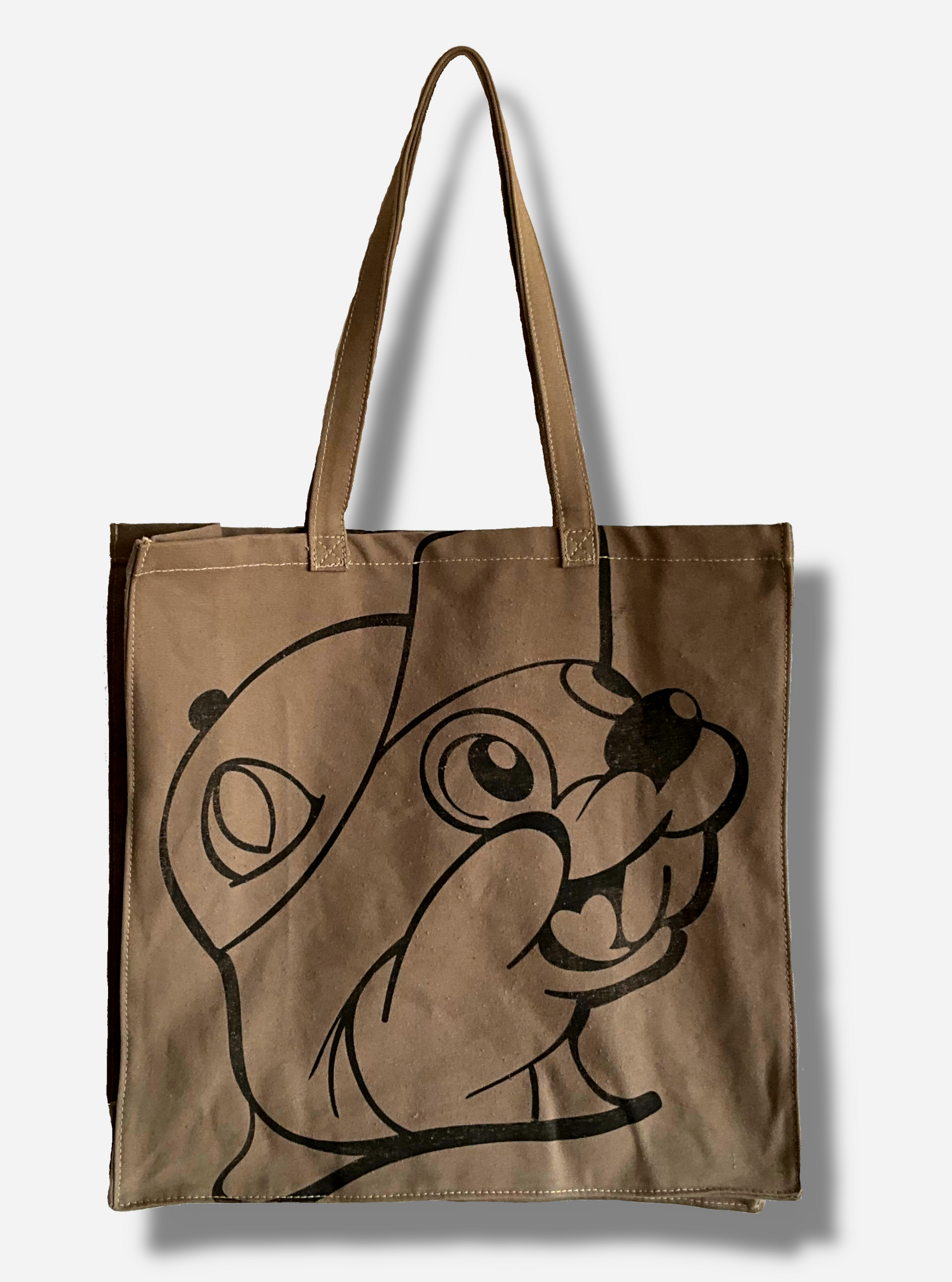 A picture of the back of a Buc-ee's Market Tote.  The tote is a large, cloth, rectangular. flat bag.  The front and back of the bag have a slightly faded black imprint of Buc-ee The Beaver's face.  Two large cloth straps are sewn to the top of the bag to make it easy to carry.