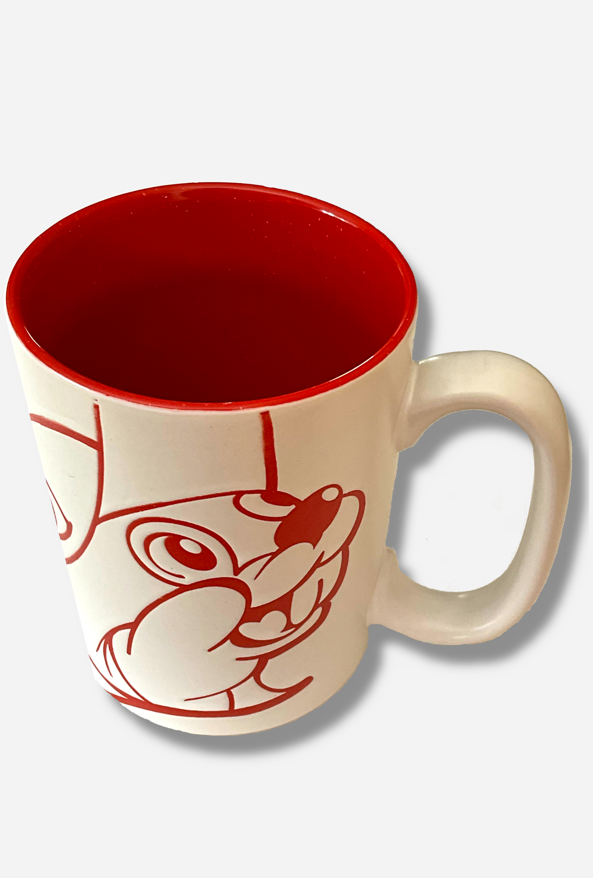 A picture of a ceramic, red and white coffee mug.  The mug prominently features a picture of Buc-ee The Beaver on the front and back, in red.  The interior of the mug is a bright red as well, and rest of the mug is white.  